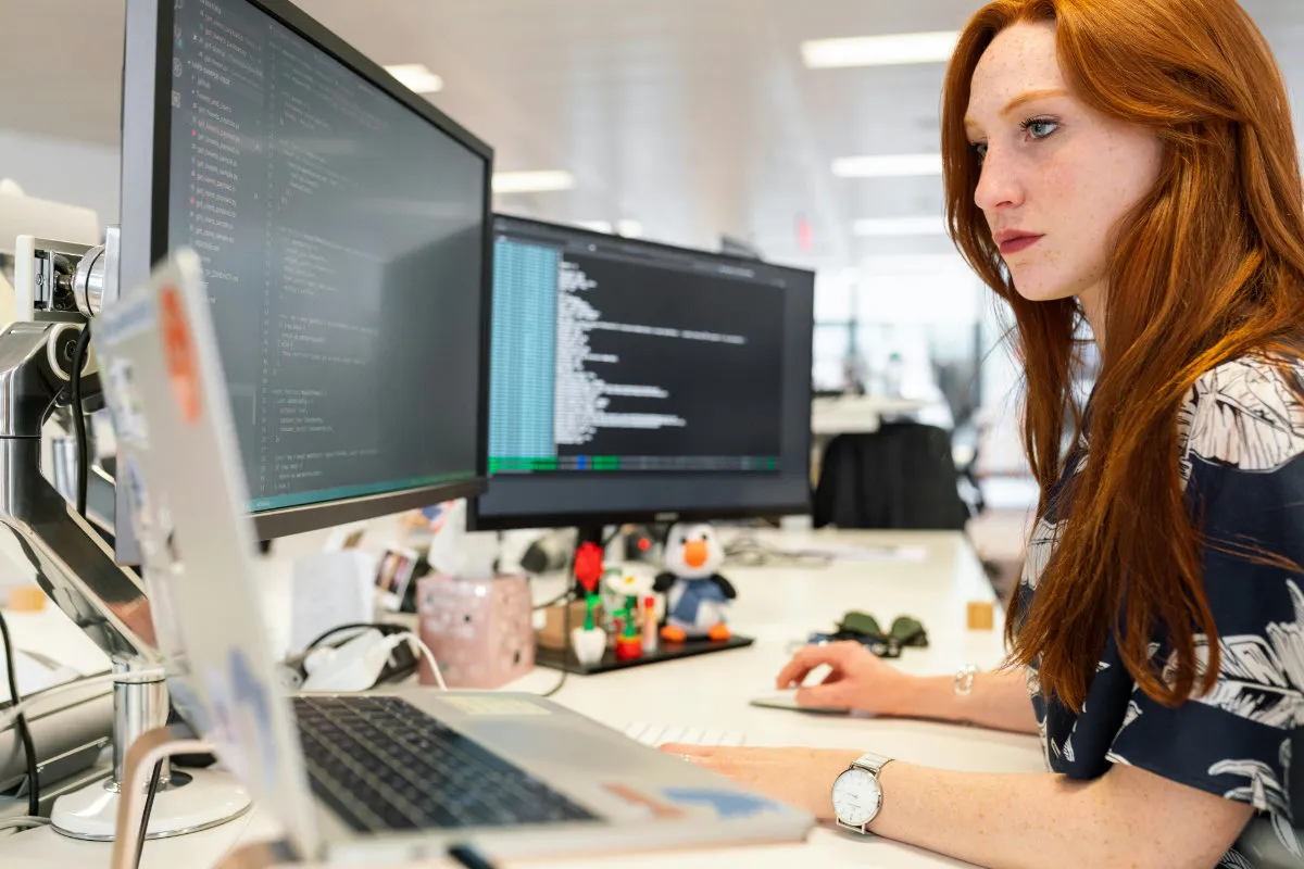 A woman working at a computer desk